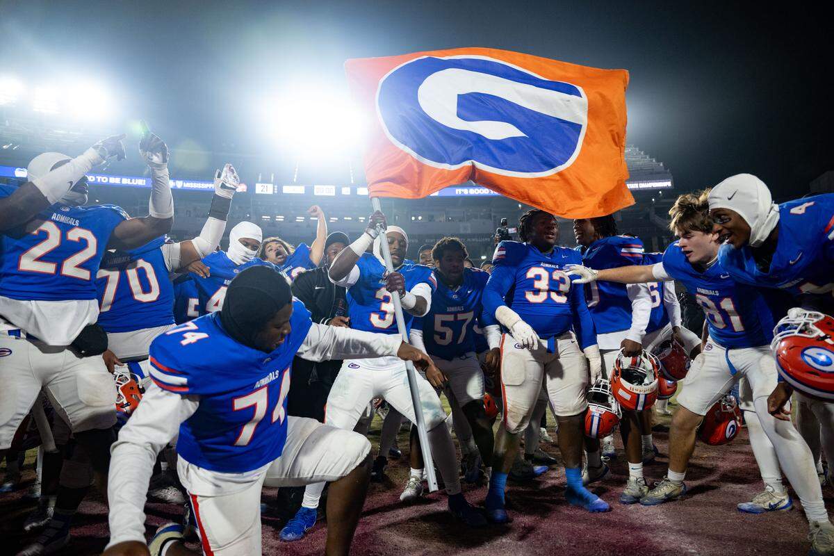Gulfport players plant their flag at midfield after winning the Class 7A championship game.