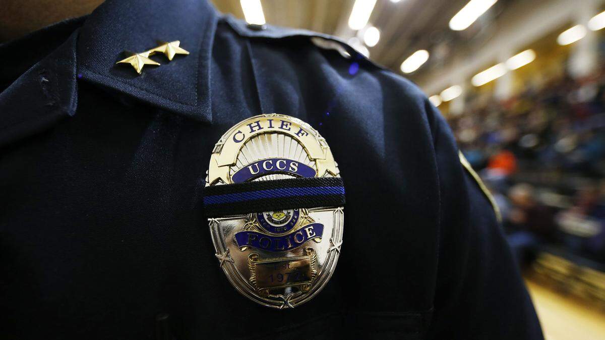 Brain McPike, chief of the University of Colorado-Colorado Springs police force, attends a vigil held on University of Colorado-Colorado Springs' campus for those killed in Friday's deadly shooting at a Planned Parenthood clinic Saturday, Nov. 28, 2015, in Colorado Springs, Colo. University of Colorado-Colorado Springs officer Garrett Swasey was among those killed in the rampage, police said. (AP Photo/David Zalubowski)