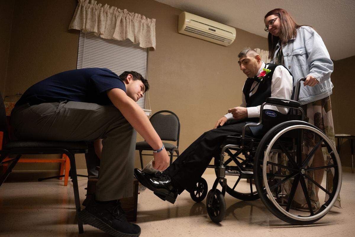 Guests of honor have their shoes shined by volunteers during Night to Shine at Woolmarket Baptist Church on Friday, Feb. 13, 2026.