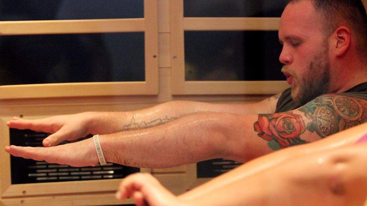 JOHN FITZHUGH/SUN HERALDJustin Mitchell does Hot Box yoga at Planet Beach in Gulfport on Dec. 9.