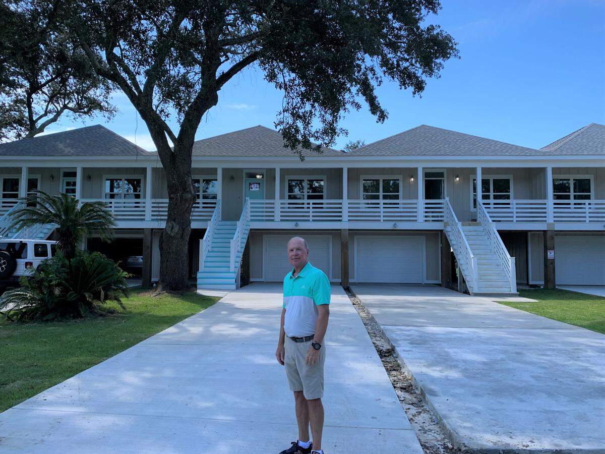 Long Beach developer Dale Stennett stands near Sandpiper Townhomes on Fifth Street that are nearly complete. He and his wife, Shelia, are building housing on empty lots throughout the city.