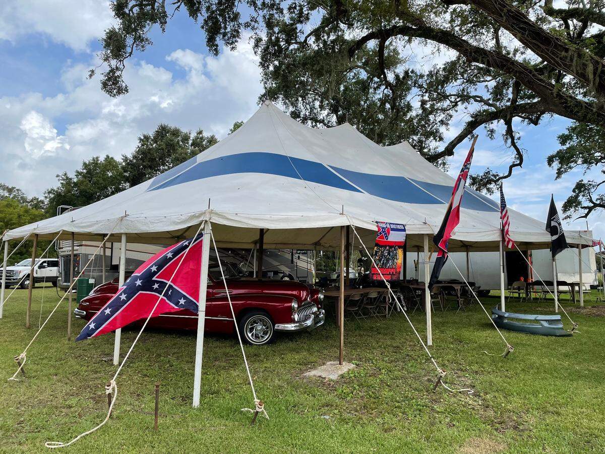 A camp site flying the Confederate battle and Mississippi 1894 state flags along with the POW and American flags at Cruisin’ The Coast in Biloxi on Oct. 4, 2021.