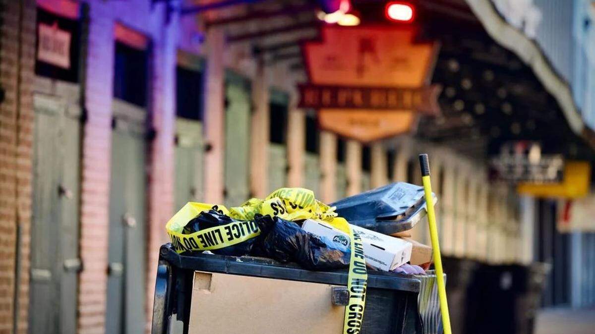 A trash can is filled with crime scene tape Monday in the Warehouse District.