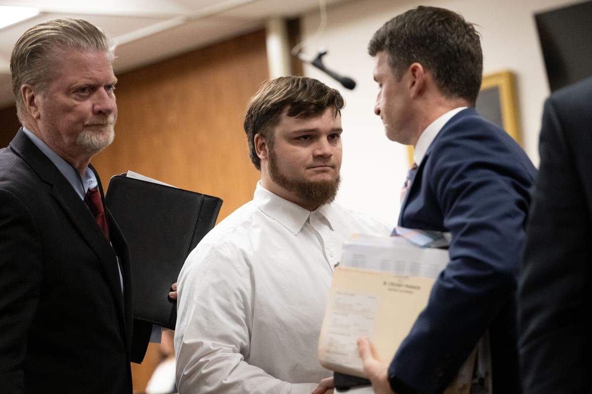 Assistant District Attorney Matthew Burrell, right, shakes hands Tuesday with Jeremy Billings, middle, after a guilty plea at Harrison County Court in Gulfport.
