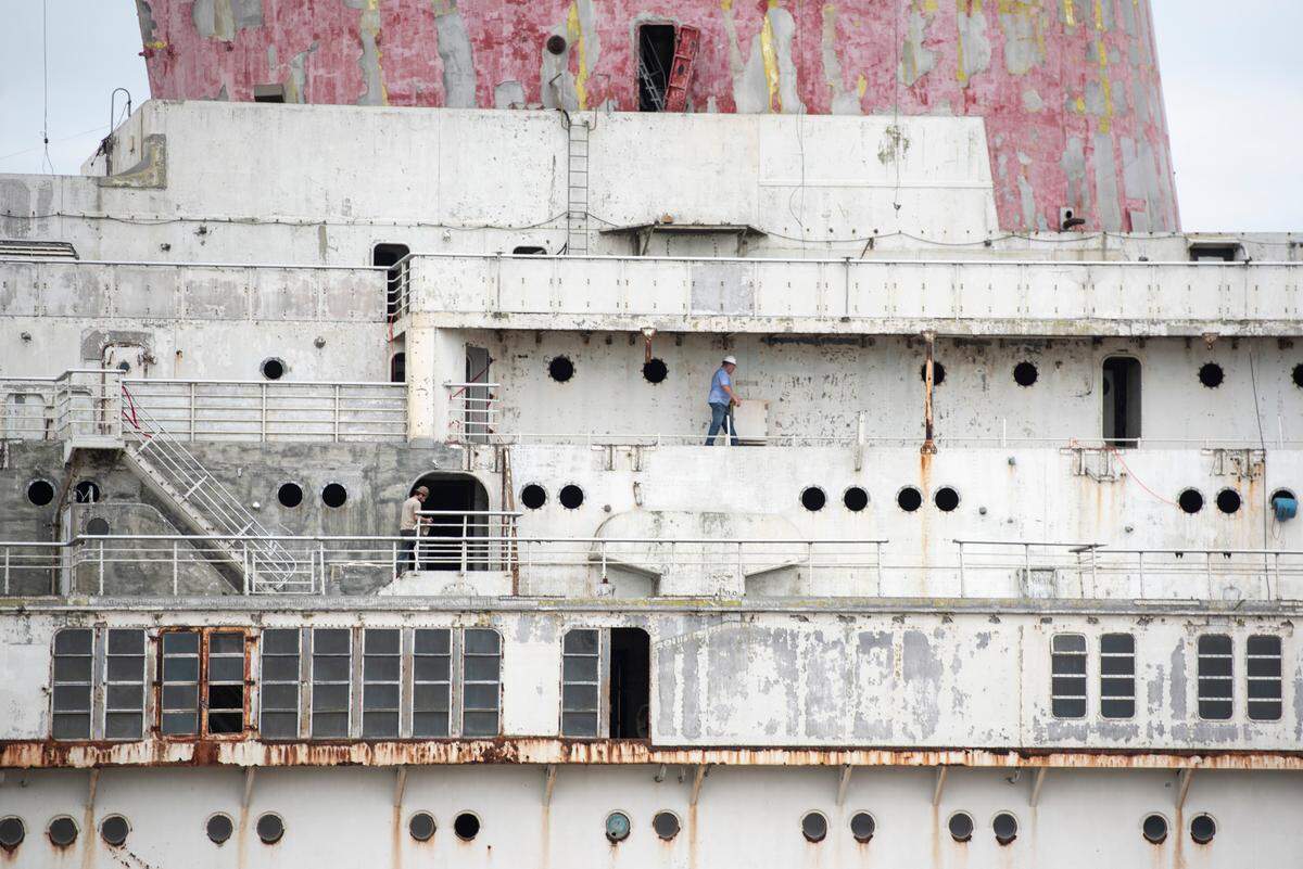 Workers strip the SS United States of any remaining hazardous chemicals and materials on Friday, March 28, 2025, before the ship will be sunk off the coast of Destin, Fl.