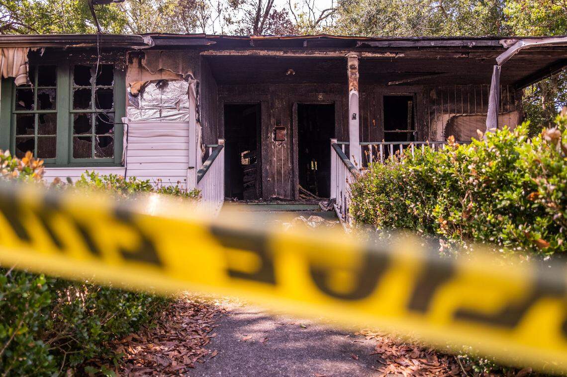 Police caution tape surrounds the burned law office of James Gray in Picayune on Aug. 15.