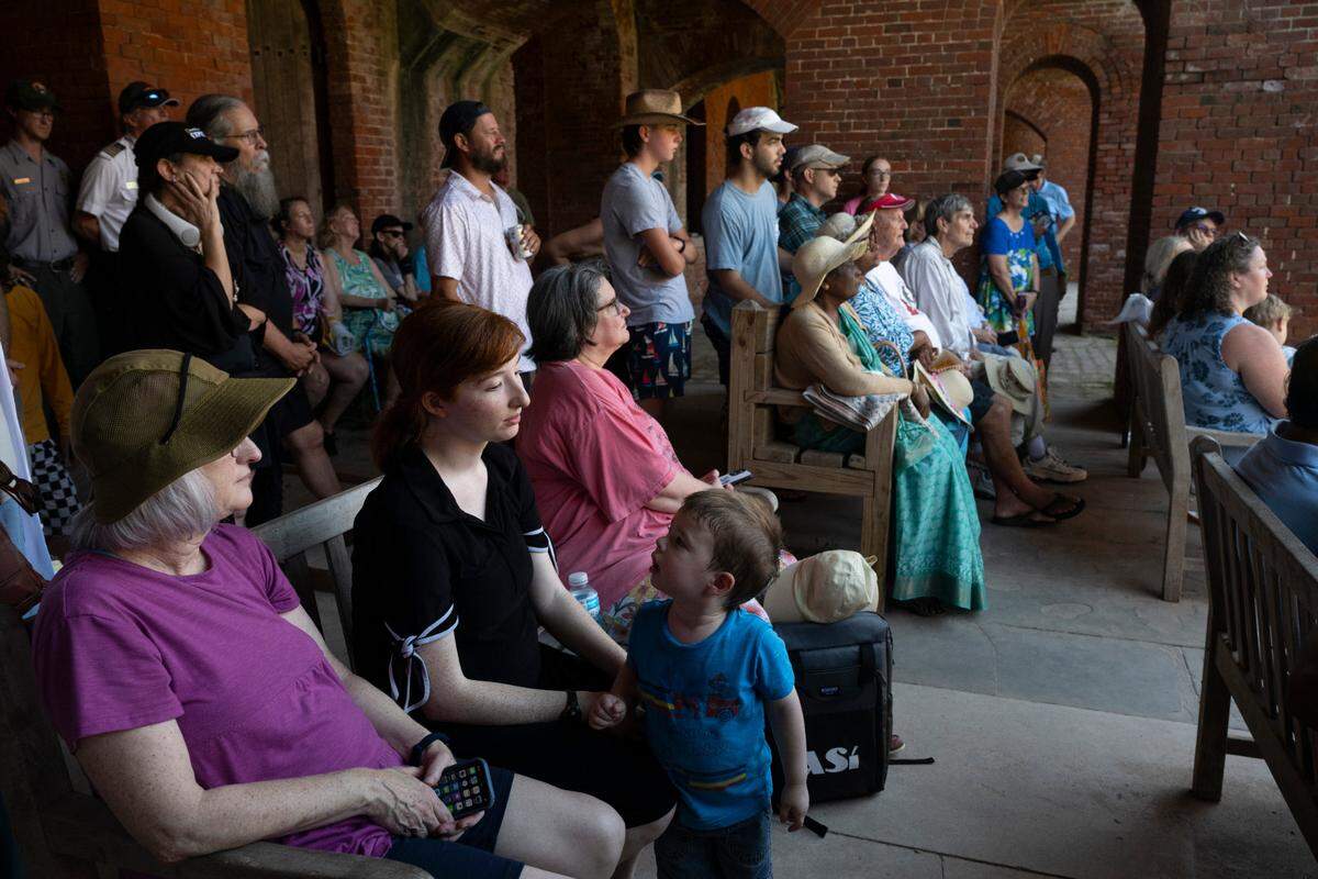 Visitors listen as Jack Madison, a volunteer tour guide for Gulf Islands National Seashore, gives one final tour of Fort Massachusetts on Friday, July 11, 2025 — his 100th birthday.