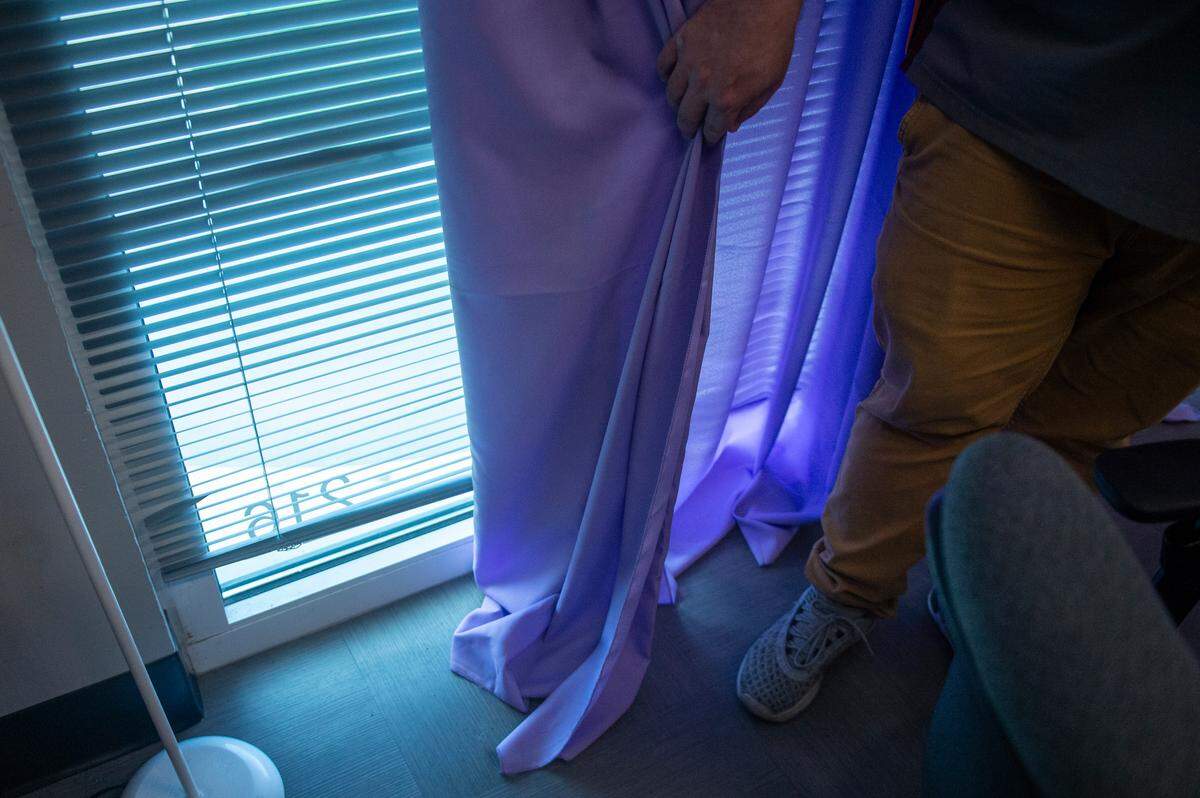 Long Beach High School Principal Justin Sutton pulls aside a curtain in a classroom at Long Beach High School on Thursday, Sept. 26, 2024, to reveal a number on the window. All of the windows at the high school have numbers on the outside so first responders can identify classrooms in the event of an emergency.