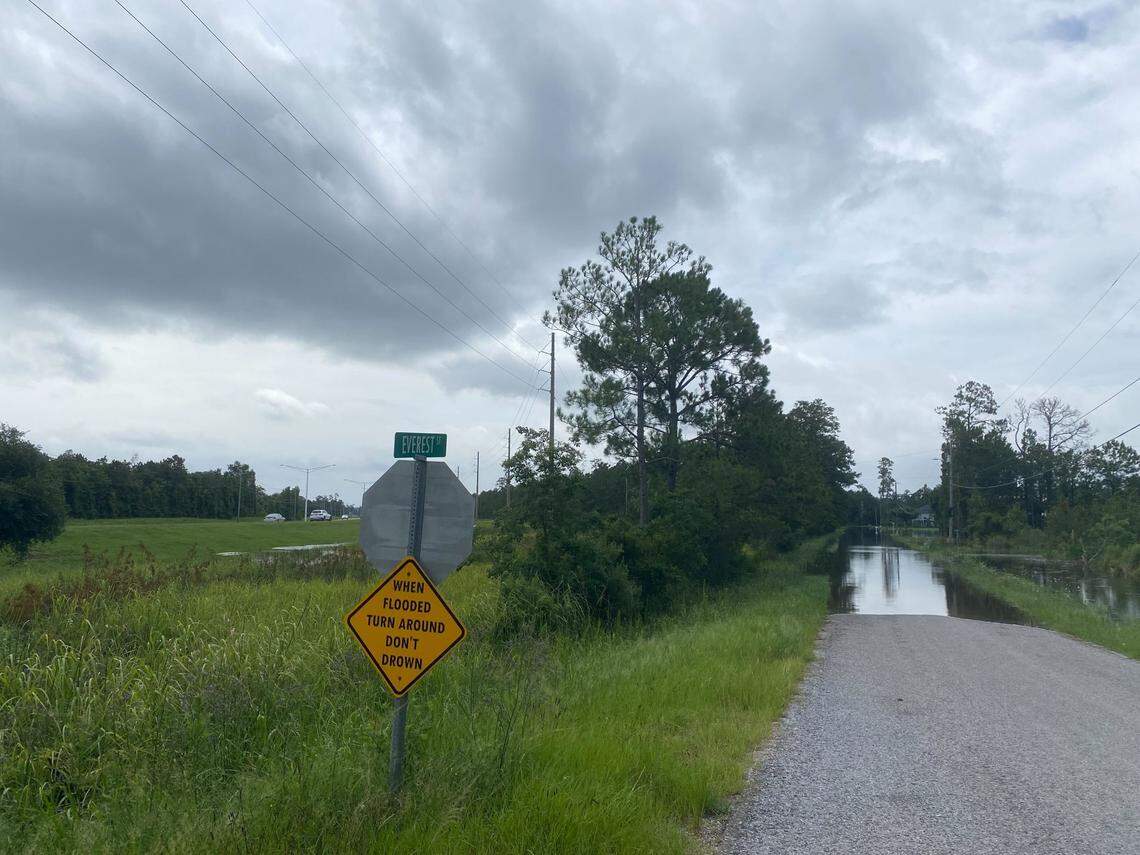 A sign urges caution Wednesday as water has covered a section of Everest Street in Shoreline Park.