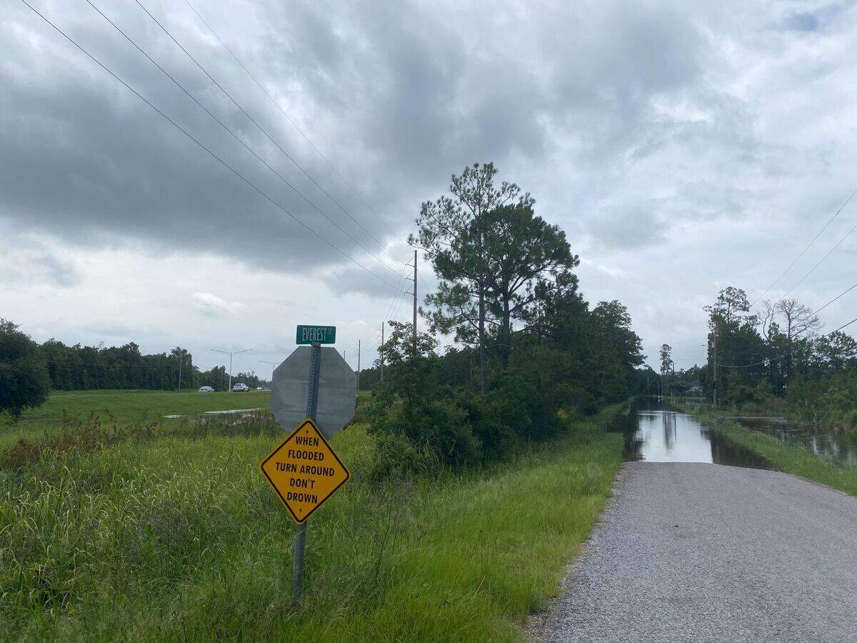A sign urges caution Wednesday as water has covered a section of Everest Street in Shoreline Park.