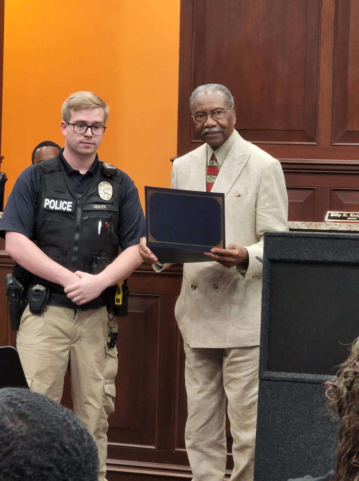 Moss Point officer Garry Mercer and Moss Point Mayor Billy Knight present Corion Evans’ with a Certificate of Commentation at a Board of Aldermen meeting Tuesday, July 5, 2022 after Evans rescued Mercer from the Pascagoula River early July 3.