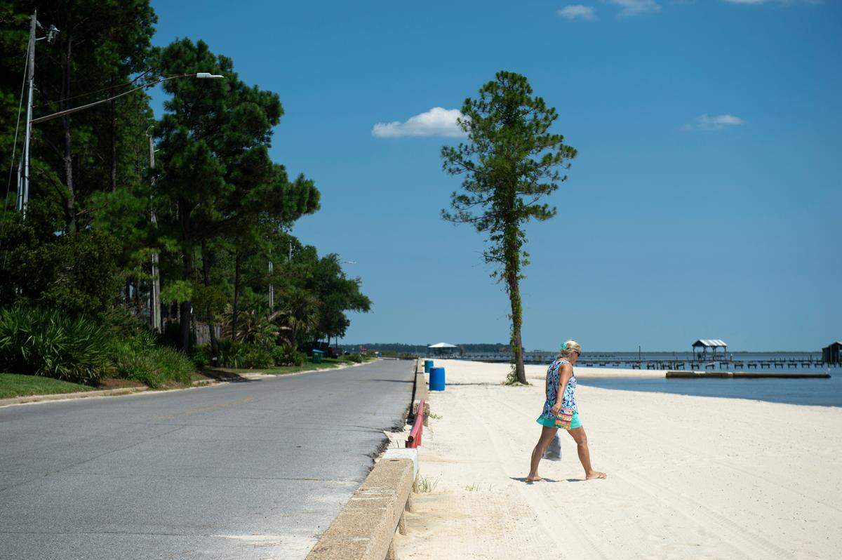 A person walks along East Beach in Ocean Springs on Tuesday, June 11, 2024. 