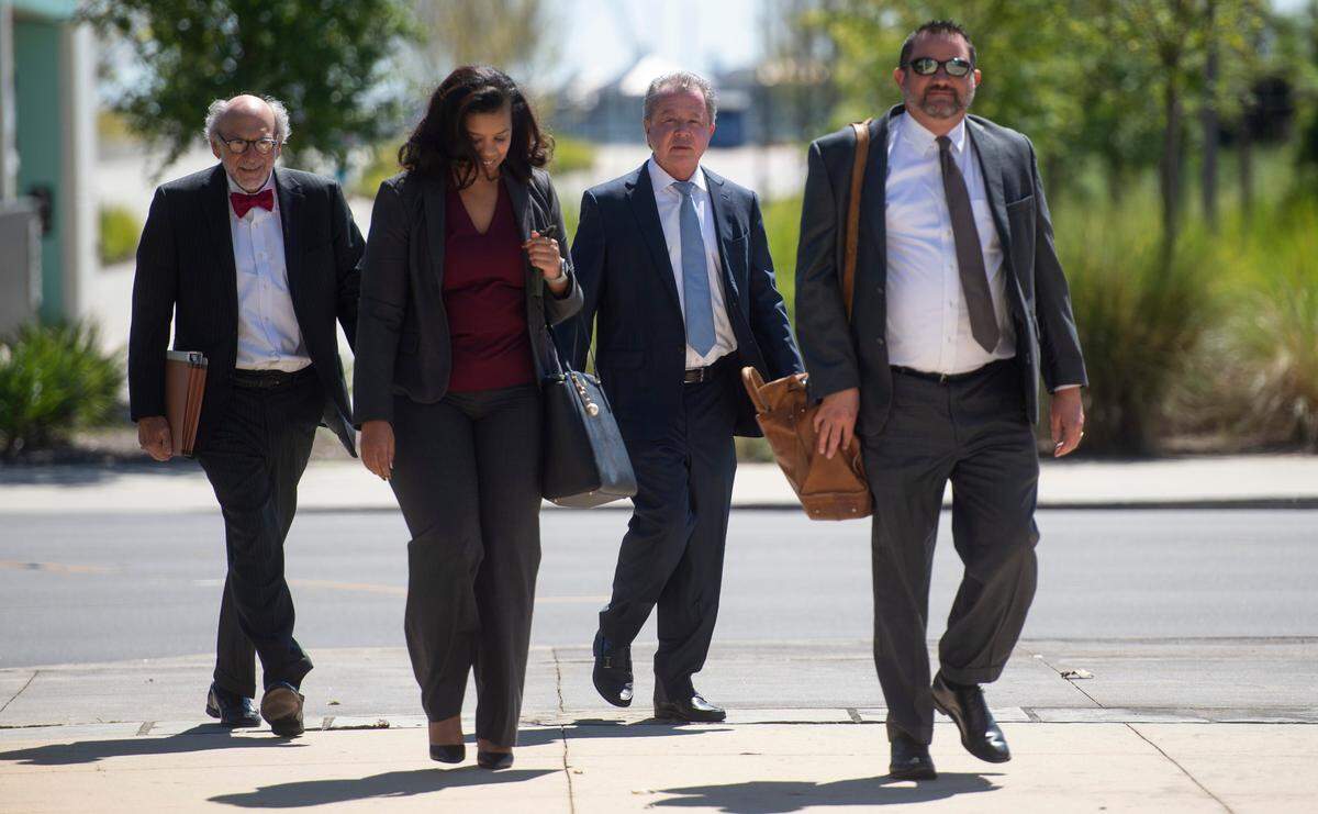 Kenneth Ritchey, center right, walks into the United States District Courthouse alongside his attorneys in Gulfport on Monday, Sept. 27, 2021.