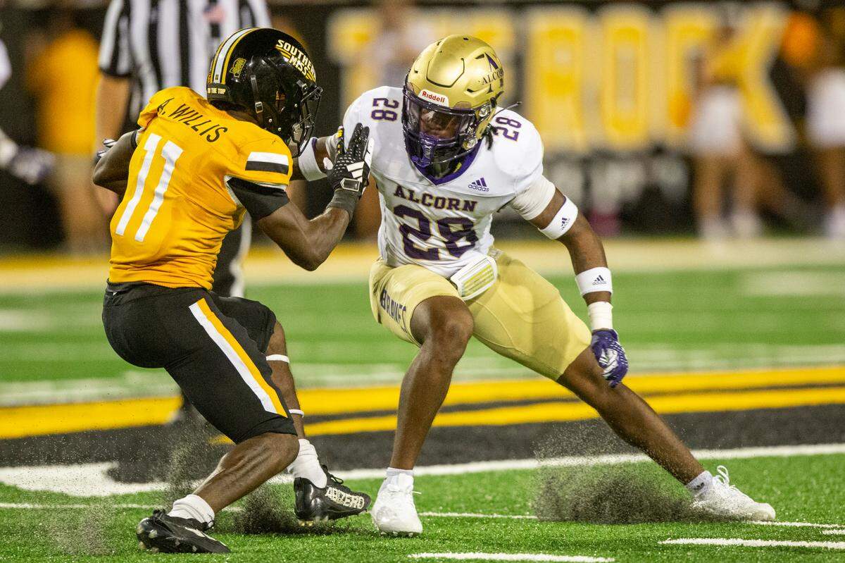Southern Miss Golden Eagles running back Antavious Willis (11) avoids Alcorn State Braves defensive back Kobe Towns (28) during a Southern Miss game at M.M. Roberts Stadium in Hattiesburg on Saturday, Sept. 2, 2023.