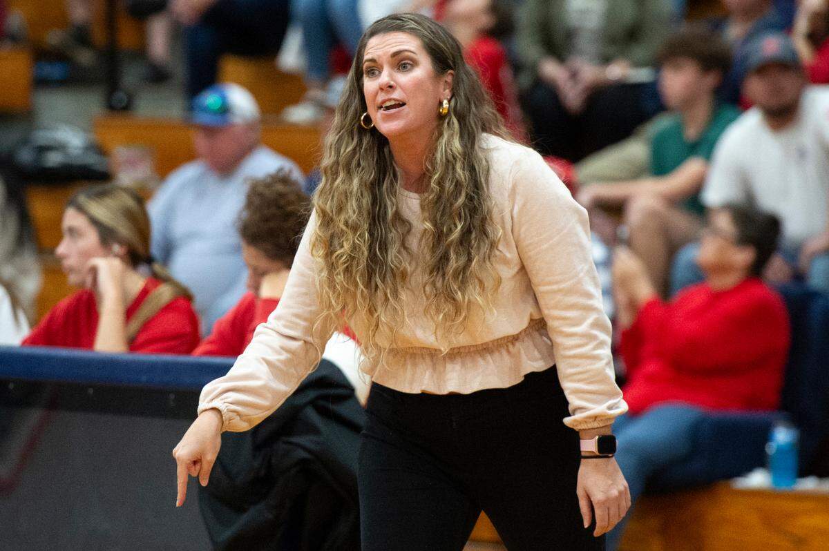 George County Rebels volleyball coach Laney Christian talks to her players during the 6A South State Championship game at Hancock High School in Kiln on Monday, Oct. 16, 2023.