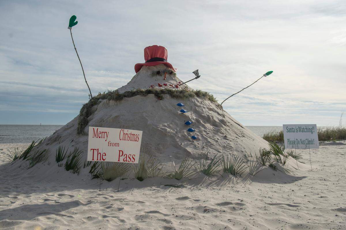 Pass Christian’s “Sandyman,” a snowman made out of sand, graces Pass Christian Beach on Thursday.