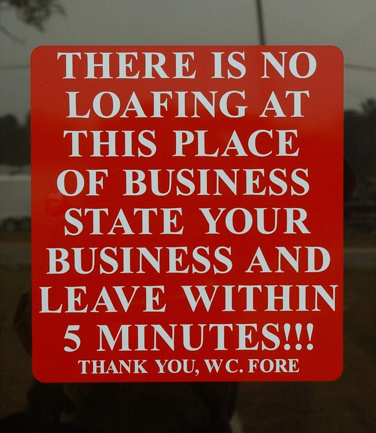 A sign on the front door of W.C. "Cotton" Fore's trucking business in Gulfport notifies visitors that time is money.