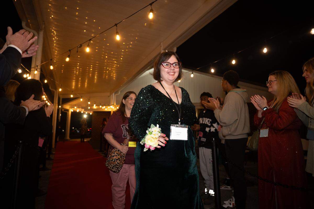 Courtnie Allen walks the red carpet with her mother, Stacie, during Night to Shine at Woolmarket Baptist Church on Friday, Feb. 13, 2026.