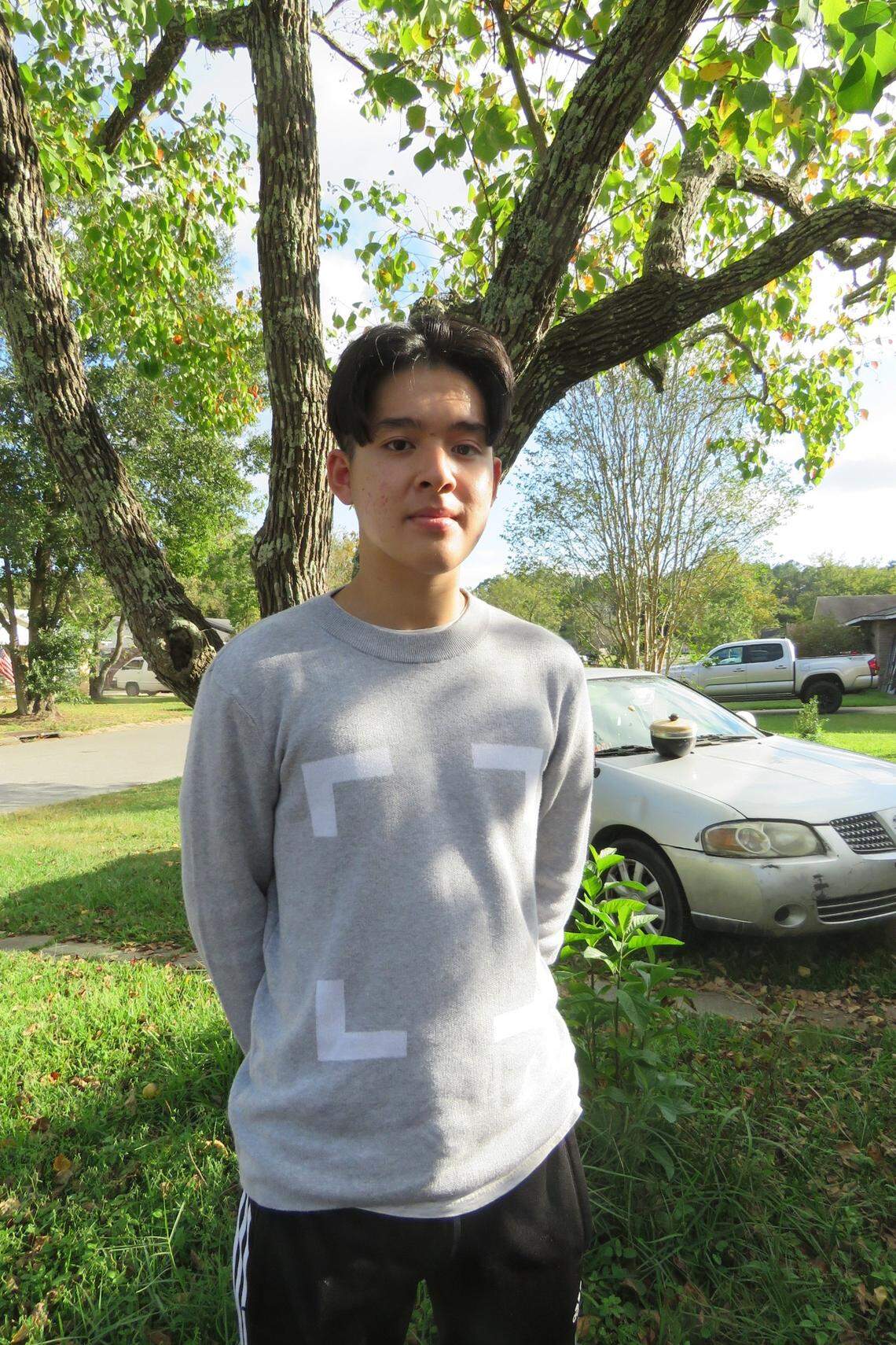High school senior Jesse Tran stands outside his father’s house in Biloxi, Mississippi on Oct. 25, 2020. Tran says he considers his political views to be still developing, and he tries hard to educate himself on every issue. “I recognize that i don’t know all that there is to know,” he said. “I would say I’m more open minded to both sides. But if I had to pick a side, I’m a little more left-leaning.”
