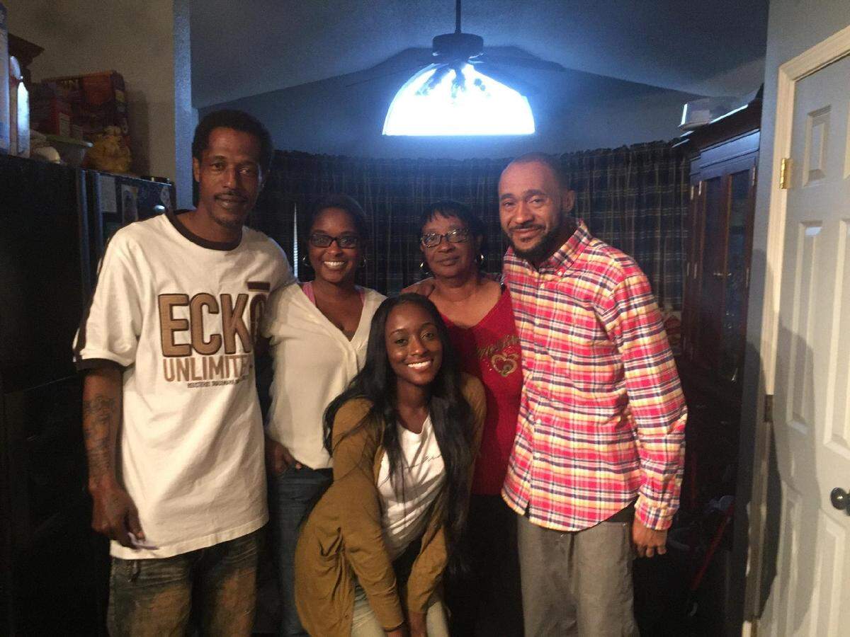 Reginald Johnson, far left, with his sister Deaundra West, mother Sandra Johnson, brother Eric Johnson, and niece (front row) at a family gathering.