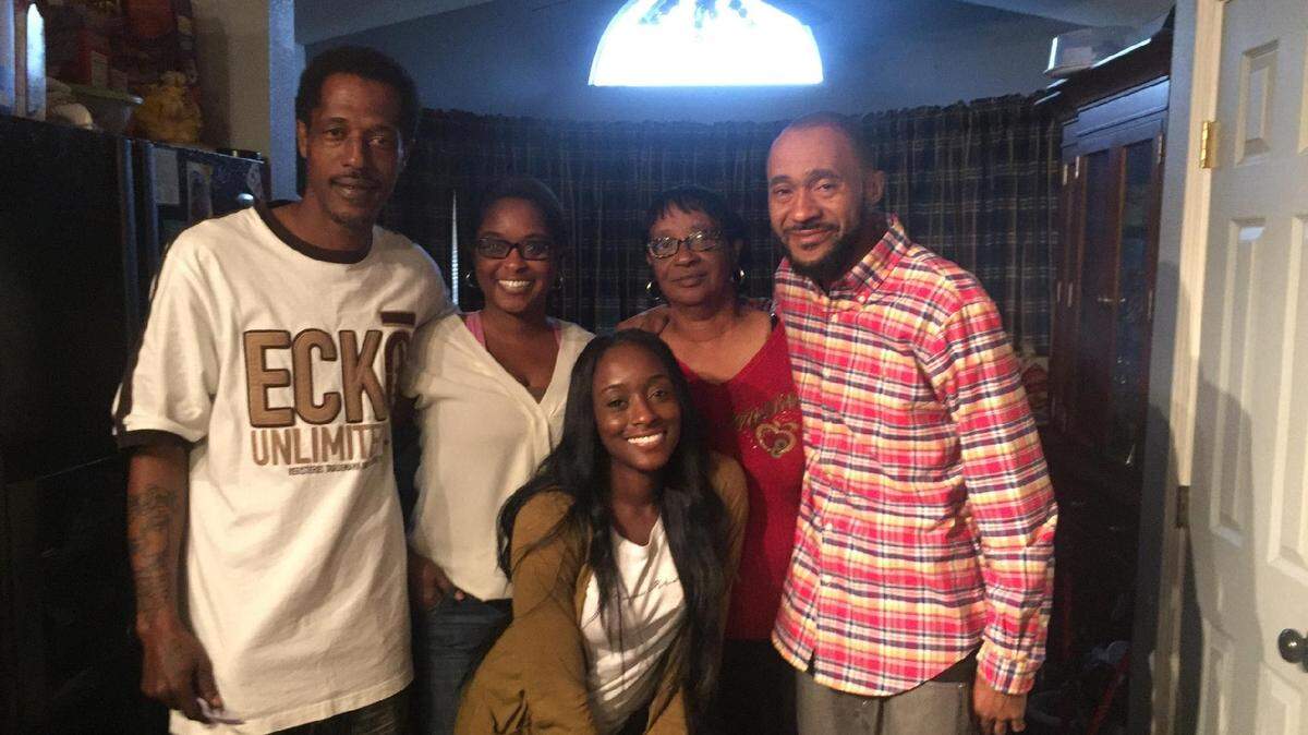 Reginald Johnson, far left, with his sister Deaundra West, mother Sandra Johnson, brother Eric Johnson, and niece (front row) at a family gathering.
