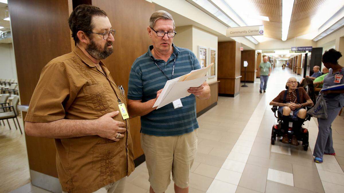 Former Armed Forces Retirement resident S. Philip Ford, left, and current resident Robert Guenther go over the new plan to phase in rent increases at the Armed Forces Retirement Home in Gulfport after a town hall meeting for residents on Thursday, July 26, 2018. The plan will phase in the increase over a three year period, the first increase coming on Jan. 1.