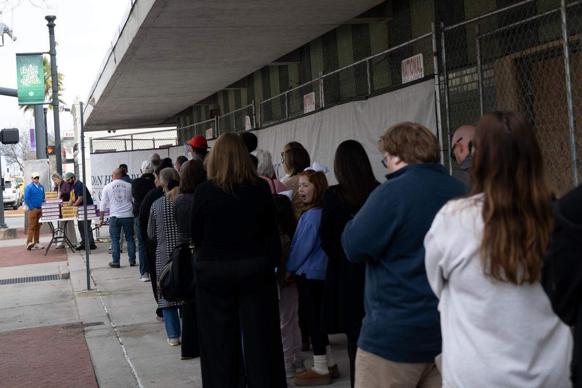 People line up outside The Downtowner for a chance to buy a Loblolly Bakery king cake.