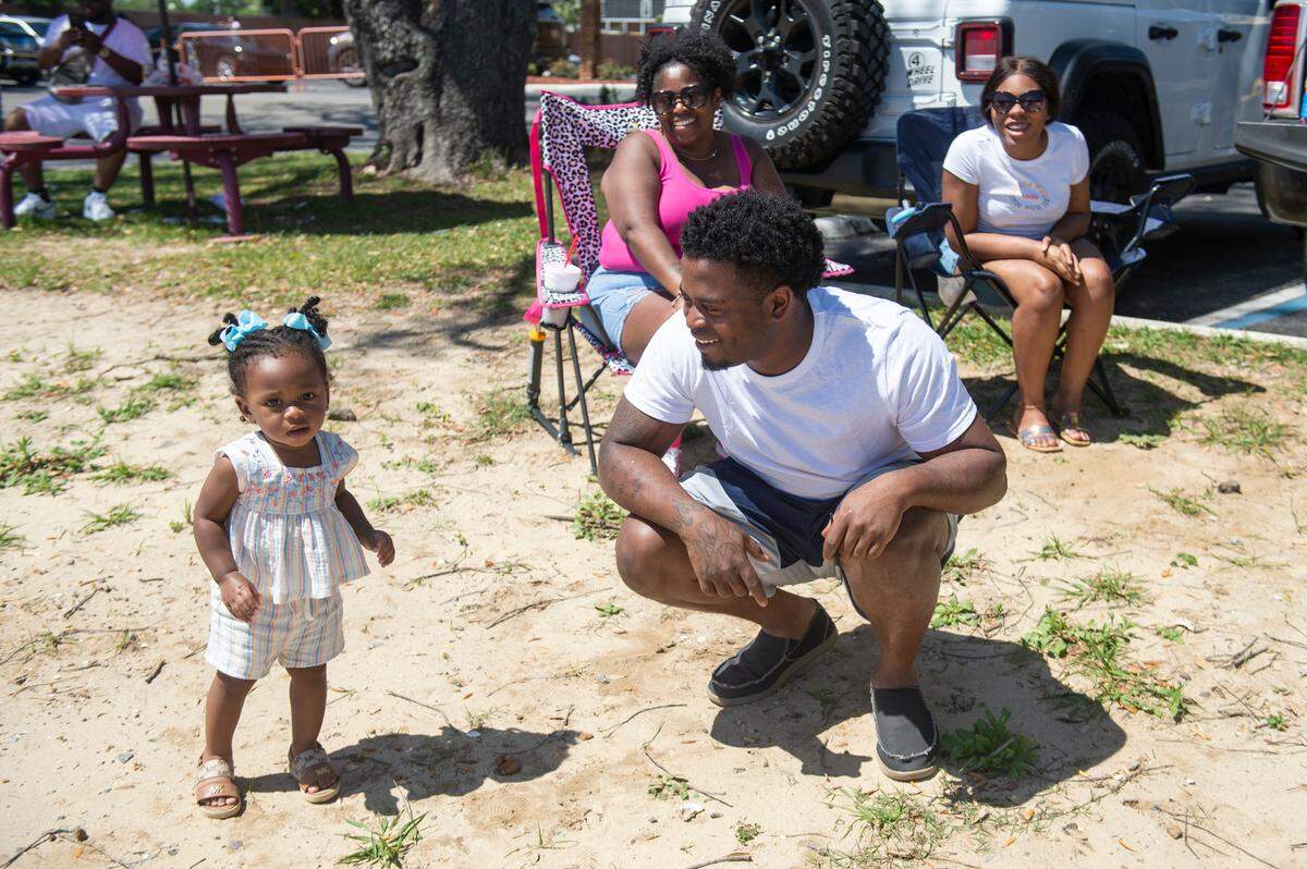 E’niyrie Ricard, 1, of Louisiana poses with her family during during Black Spring Break in Biloxi on Saturday, April 13, 2024.