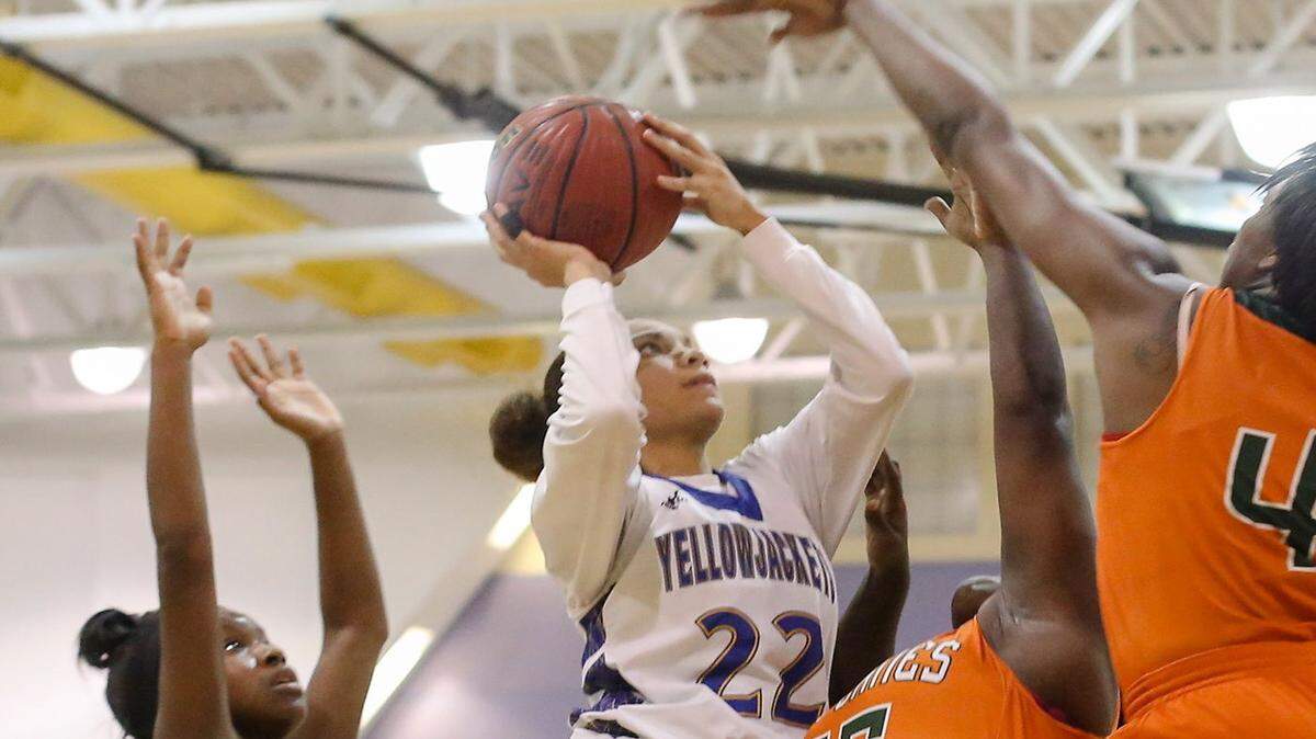 AMANDA McCOY/SUN HERALD 
 St. Martin's Savannah Jones shoots a basket while surrounded by the West Harrison defense on Tuesday, December 8, 2015, at St. Martin High. St. Martin defeated West Harrison, 64-41.