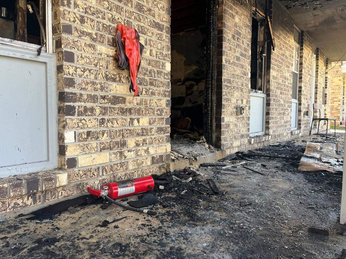 The heat from Tuesday’s fire melted the holder for a fire extinguisher Tuesday at Sugar Mill Apartments in Gulfport.