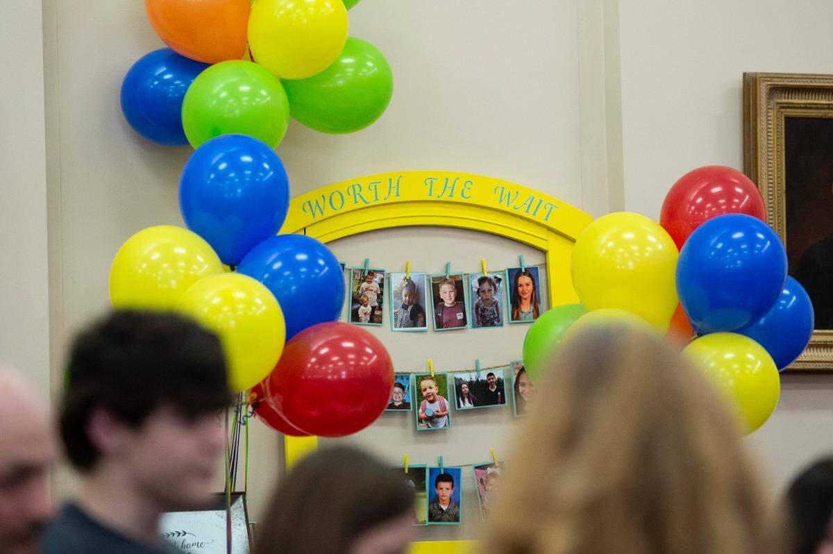 Portraits of adopted children decorate the courtroom during Adoption Day at Jackson County Court in Pascagoula on Thursday, March 10, 2022.