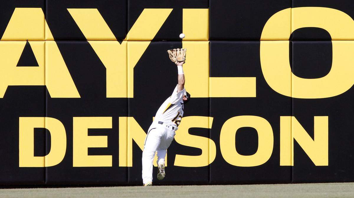 TIM ISBELL/SUN HERALDSouthern Miss center fielder Jake Sandlin makes a catch at the wall in last weekend's series against Rice.