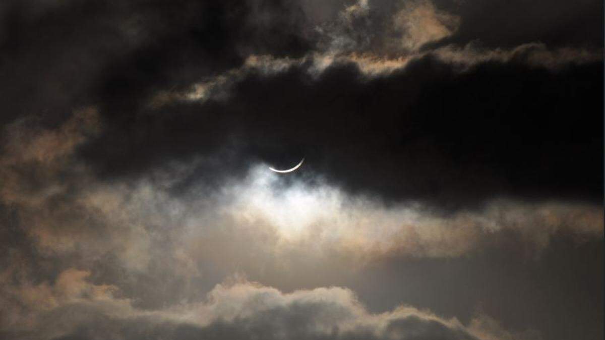 Clouds partially cover a solar eclipse visible from the northern tip of Australia in 2012. Partially cloudy skies are expected along the Mississippi Coast during Monday’s solar eclipse.