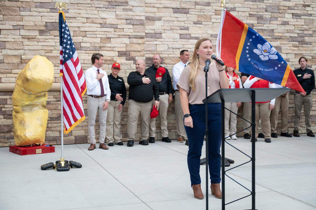 The national anthem is sung in front of a sculpture of a beaver nugget during a ribbon cutting ceremony for Buc-ee’s first Mississippi location in Harrison County on Monday, June 9, 2025.