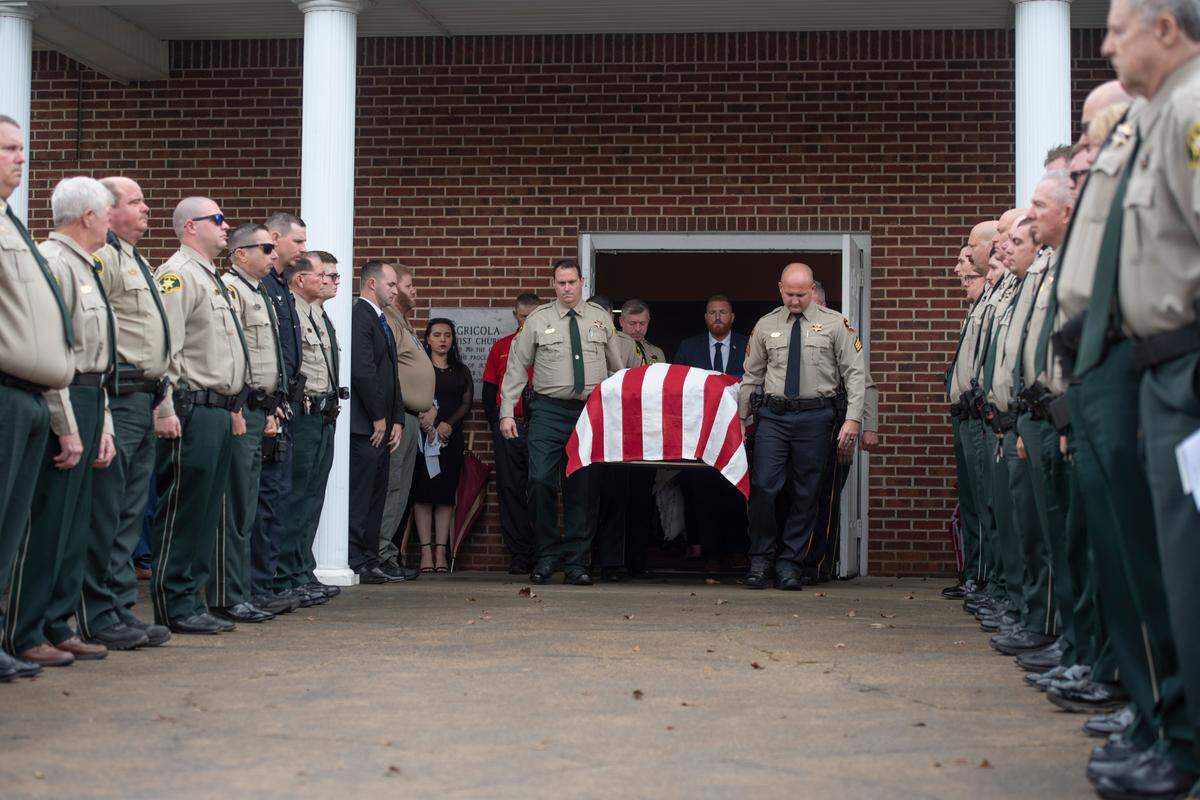 Members of law enforcement carry the casket of George County Sheriff’s Deputy Jeremy Malone to the hearse following Malone’s funeral at Agricola Baptist Church in George County on Friday, Jan. 12, 2024.