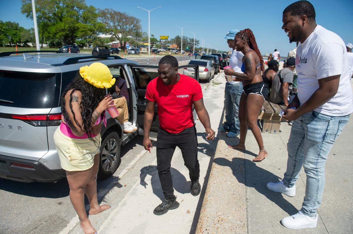 Beachgoers dance and chat during Black Spring Break on Saturday, April 12, 2025.