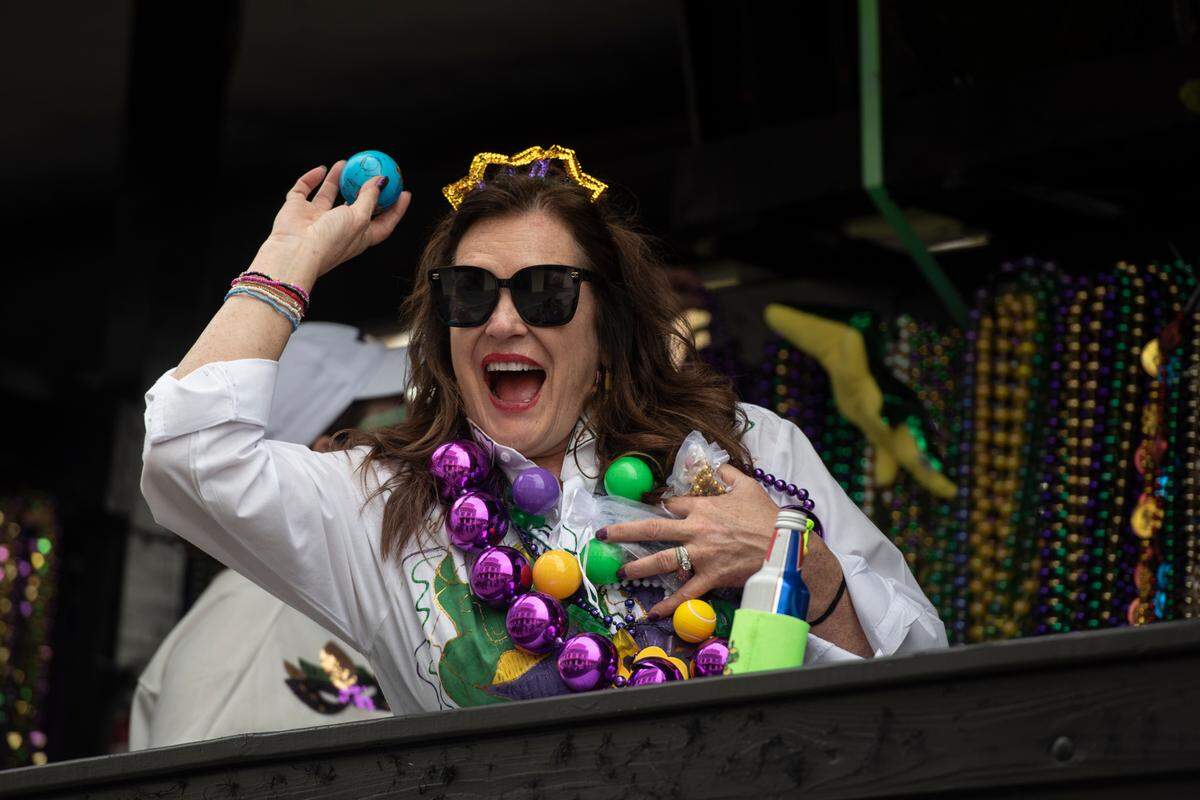A float rider throws a ball from a float during the Krewe of Gemini parade in downtown Gulfport on Saturday, Feb. 10, 2024.