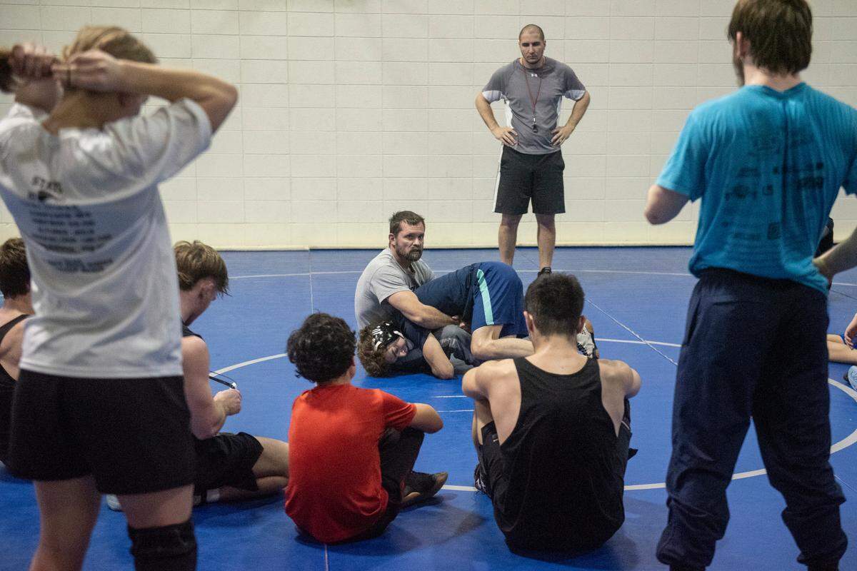 Ocean Springs’ wrestling coach Jay Snow gives a demonstration during Ocean Springs’ high school wrestling practice at E.H. Keys Alternative Education Center on Thursday, Feb. 8, 2024.