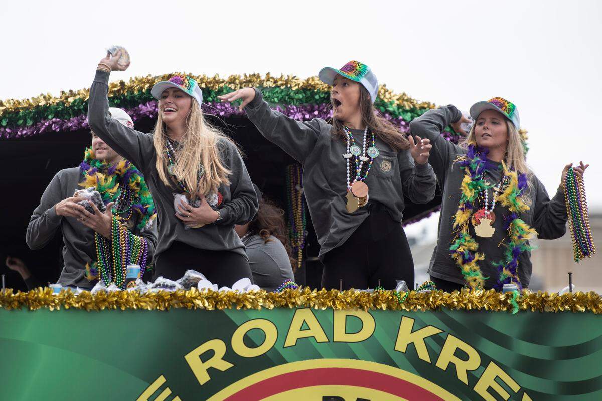 Float riders throw beads to the crowd during the Gulf Coast Carnival Association Mardi Gras parade in Biloxi on Tuesday, March 4, 2025.