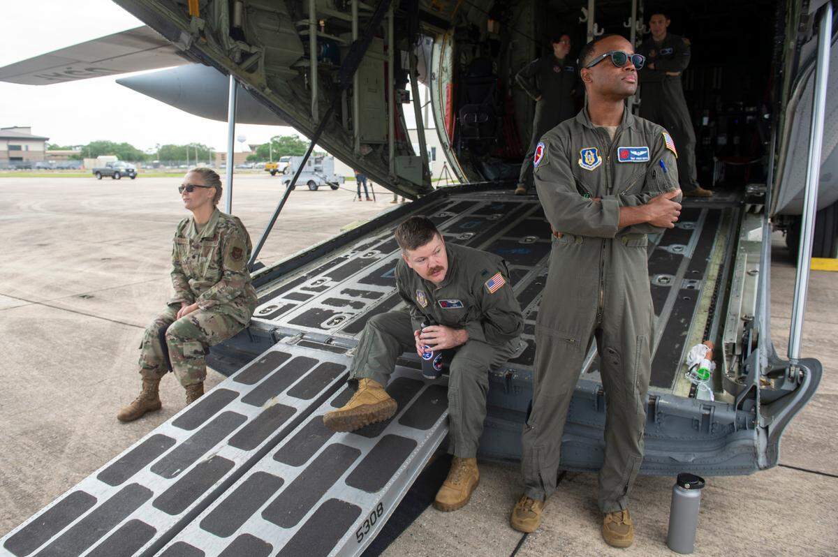 Members of the 53rd Weather Reconnaissance Squadron, also known as Hurricane Hunters, sit on the back of a C-130 during a media day at Keesler Air Force Base on Tuesday, May 6, 2025. Hurricane Hunters fly directly into hurricanes to measure weather data around the storms.