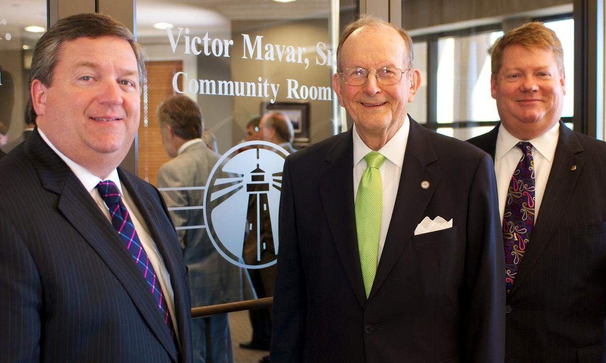 Victor Mavar Sr., center, is honored as the Victor Mavar Community Room at Hancock Whitney Bank was named in tribute to his many years as a bank director. Mavar, a Biloxi businessman, politician and family man, died Saturday.
