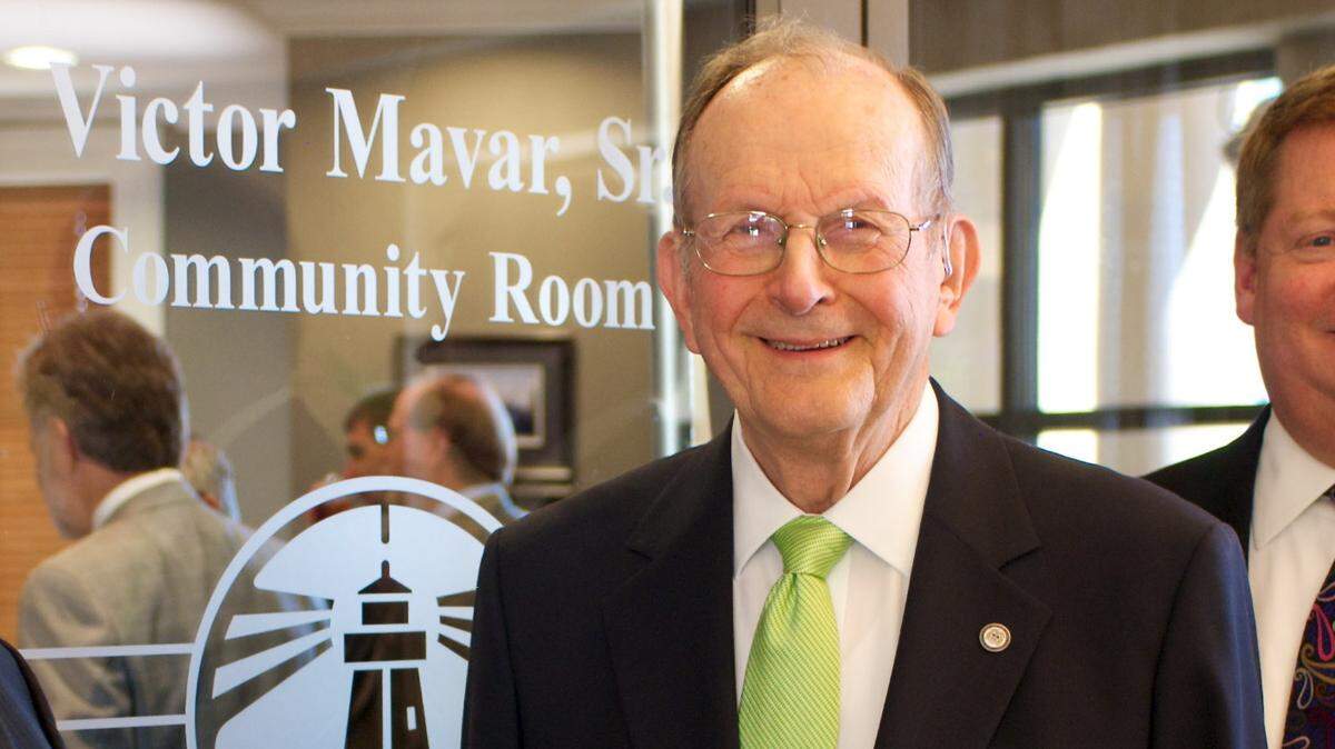 Victor Mavar Sr., center, is honored as the Victor Mavar Community Room at Hancock Whitney Bank was named in tribute to his many years as a bank director. Mavar, a Biloxi businessman, politician and family man, died Saturday.