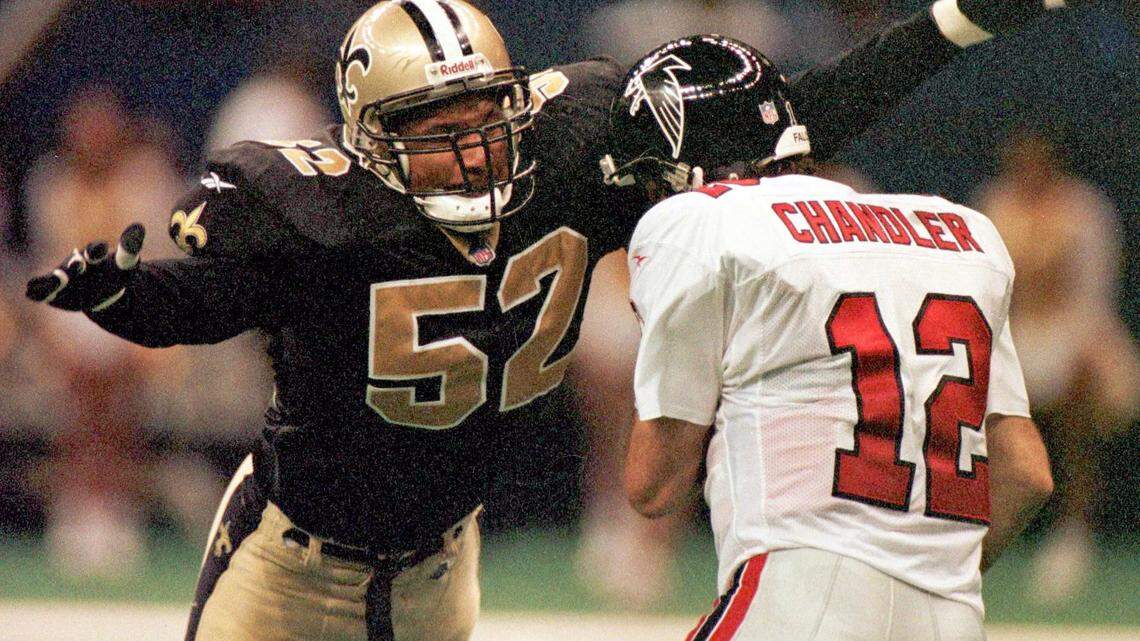 ASSOCIATED PRESS 
 New Orleans Saints linebacker Richard Harvey (52) sacks Atlanta Falcons quarterback Chris Chandler (12) during in this 1997 photograph.
