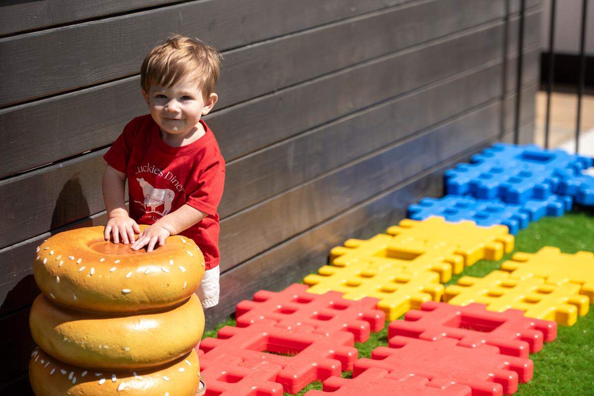 Riley Ferguson, son of Luckies Diner owners Byren and Hanna Ferguson, plays in the kids play area adjacent to the diner in Vancleave on Monday, March 10, 2025.