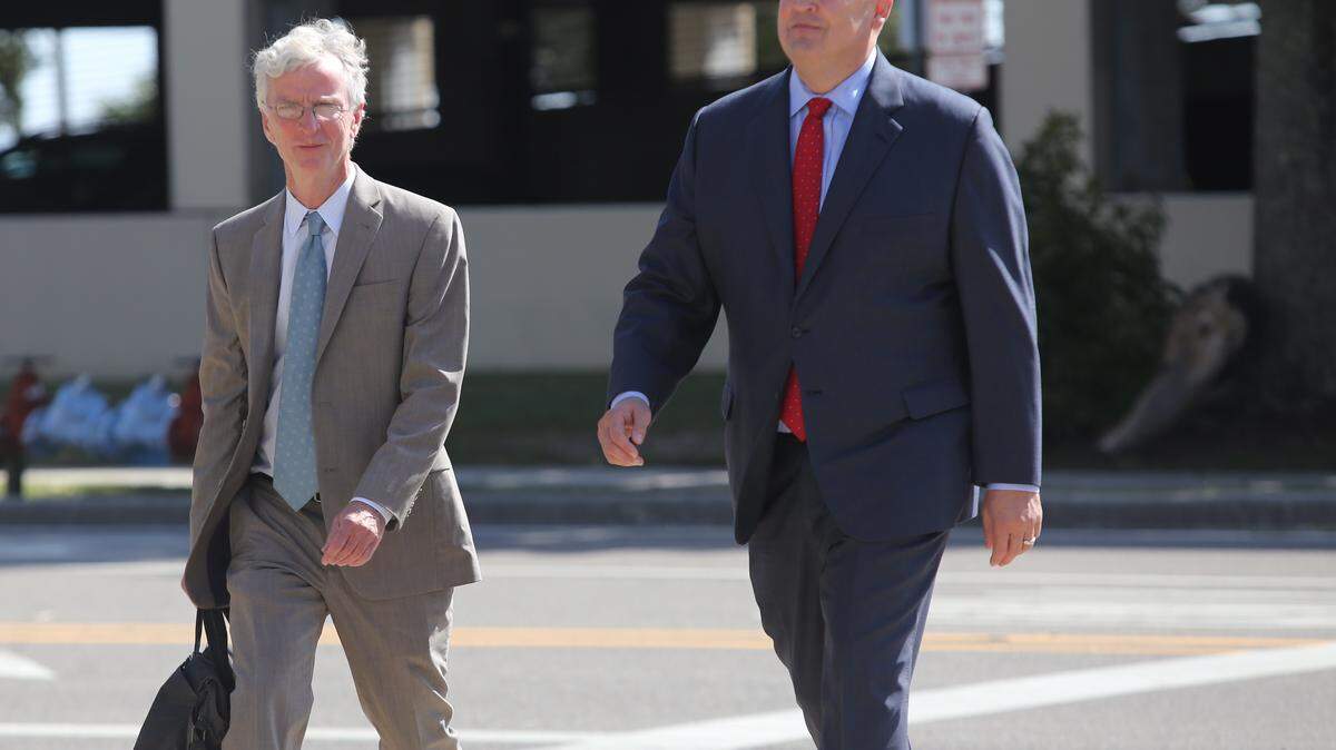 San Antonio attorney Mikal Watts, right, leaves the federal courthouse in Gulfport Oct. 29 after he pleaded not guilty in a 95-count indictment charging him and six others with BP fraud. He was with his attorney, Robert McDuff of Jackson.