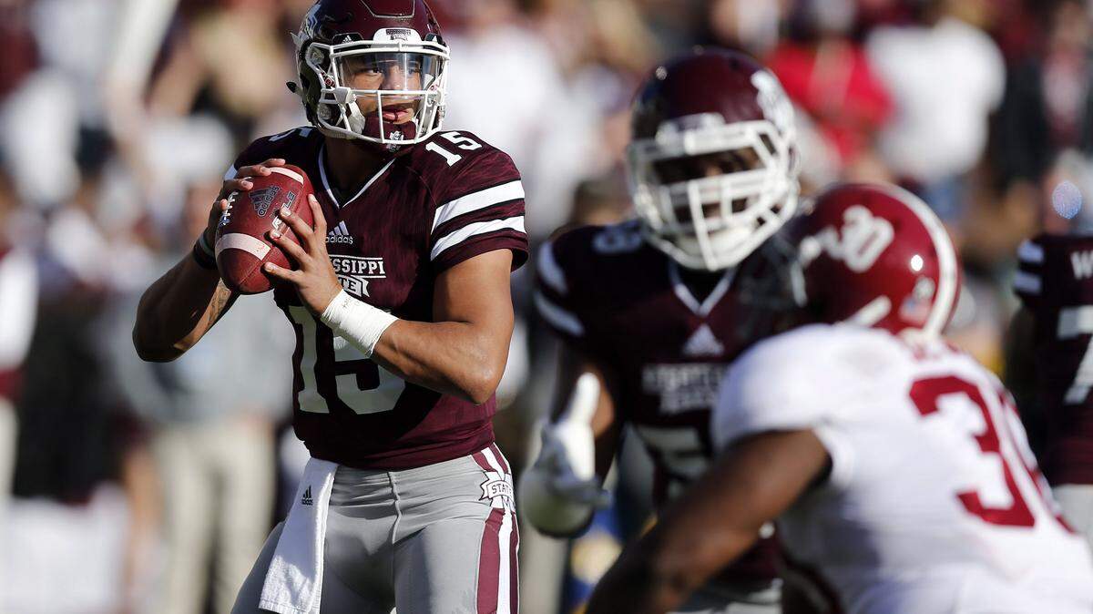 Mississippi State quarterback Dak Prescott (15) looks for an open receiver as he is pressured by Alabama linebacker Denzel Devall (30) during the first half of an NCAA college football game in Starkville, Miss., Saturday, Nov. 14, 2015. (AP Photo/Rogelio V. Solis)