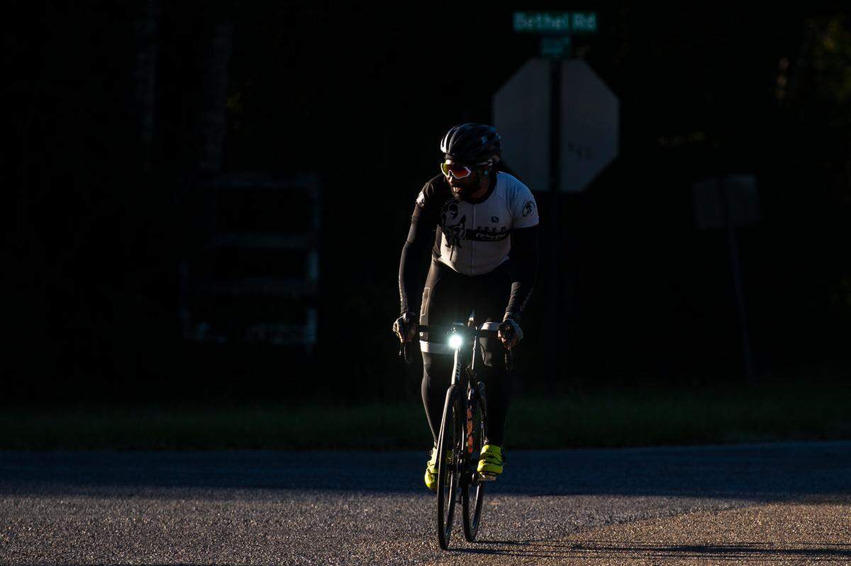 A member of the Major Taylor Cycling Club of Louisiana bikes through an intersection in Woolmarket in this Sun Herald file photo. Work could begin in 2026 for a bicycle, running and walking path in South Mississippi.