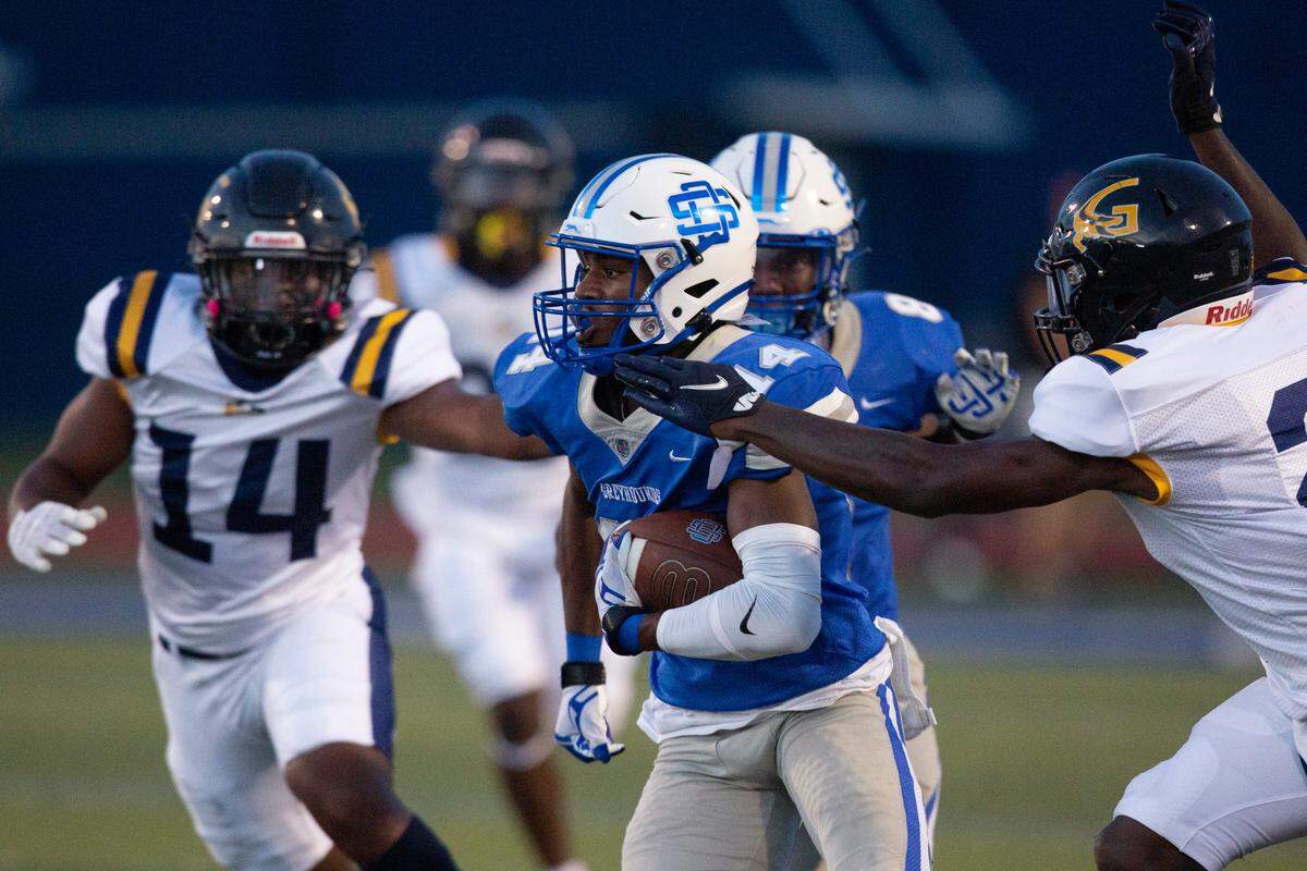 Ocean Springs’ J.P. Coulter gets tackled by Gautier during a Jamboree game at Greyhound Stadium in Ocean Springs on Friday, Aug. 19, 2022.