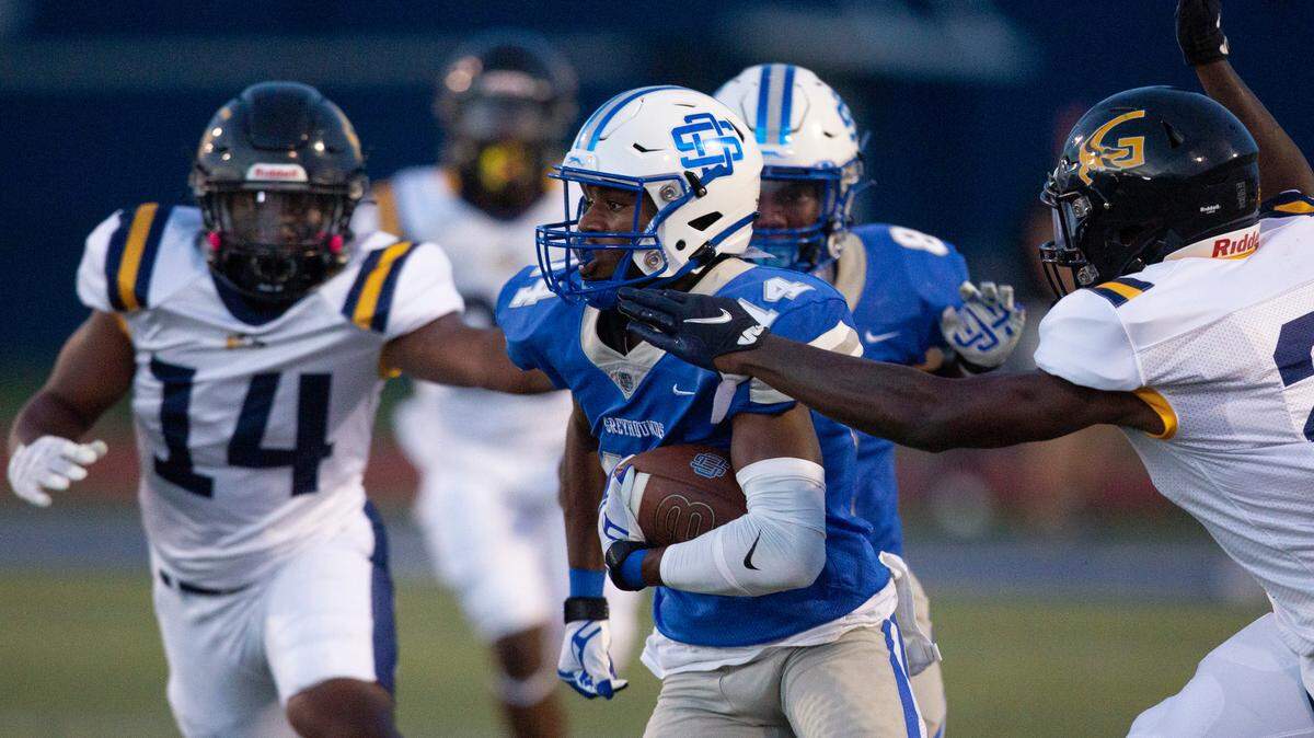 Ocean Springs’ J.P. Coulter gets tackled by Gautier during a Jamboree game at Greyhound Stadium in Ocean Springs on Friday, Aug. 19, 2022.