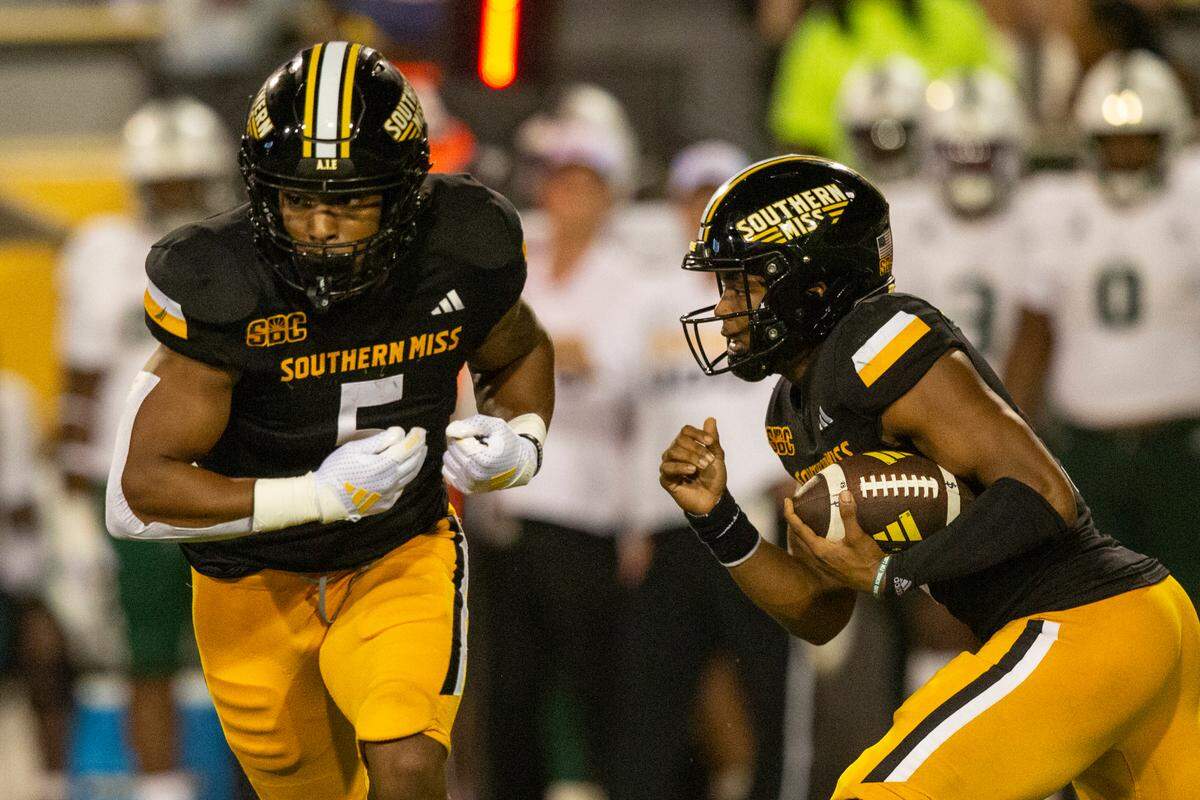 Southern Miss Golden Eagles quarterback Ethan Crawford (3) fakes a handoff to Southern Miss Golden Eagles running back Kenyon Clay (5) during a game between Southern Miss and South Florida at M.M. Roberts Stadium in Hattiesburg on Saturday, Sept. 14, 2024.